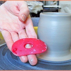 Pottery Tool Guide List a picture of a potter hodling a small red rib