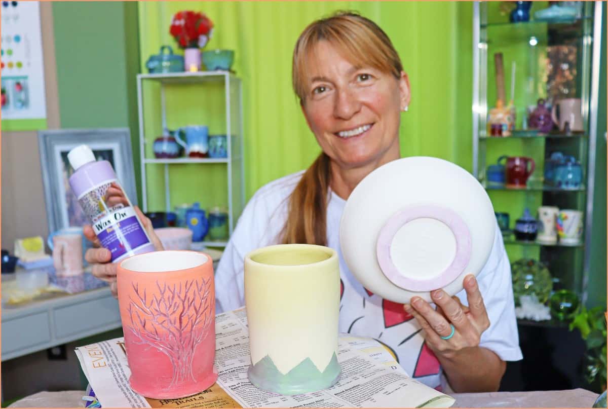 a picture of a potter holding wax resist and wax resist item