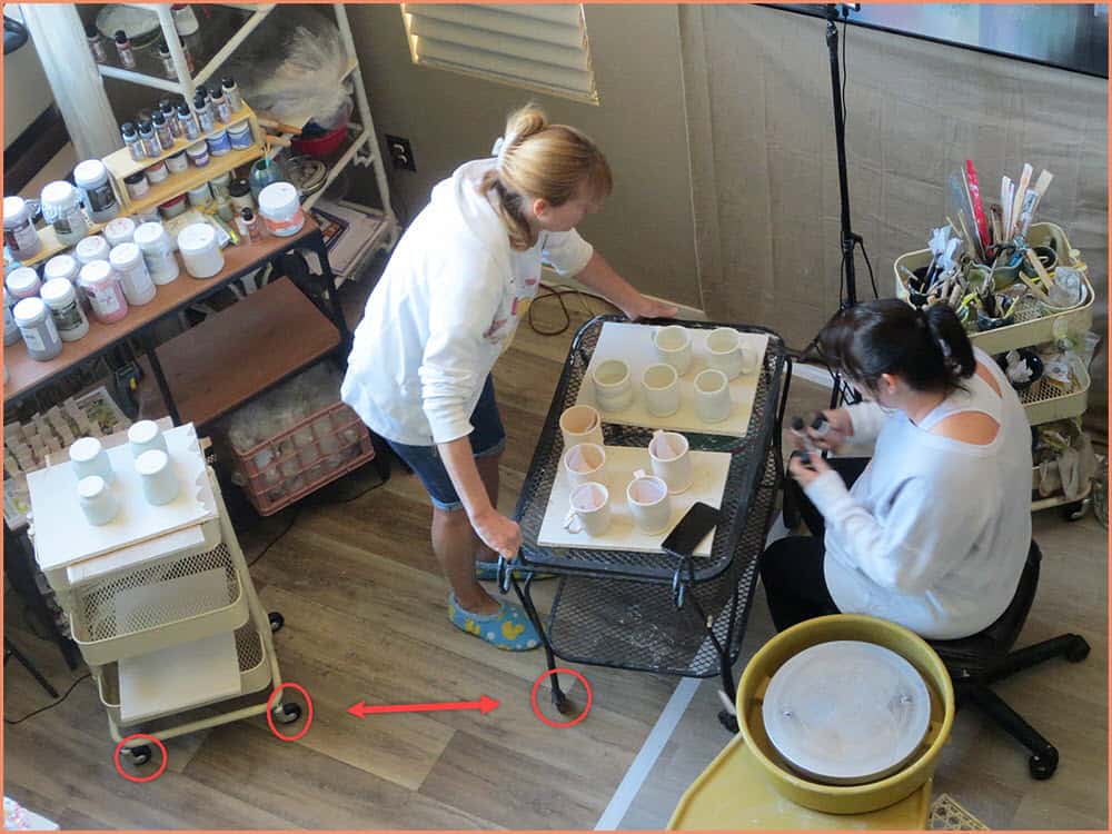 a picture of 2 potters working on a cart