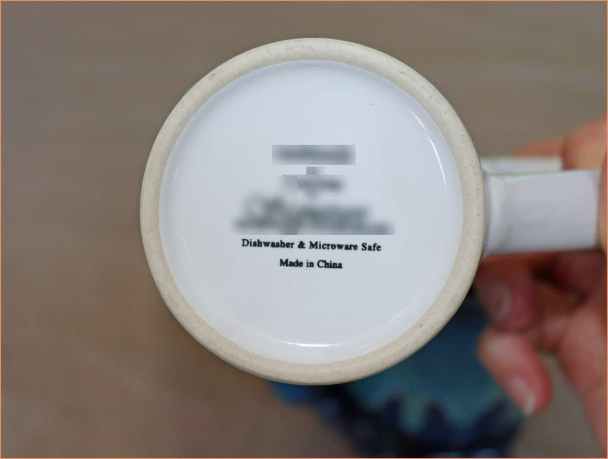 a picture of a potter hloding dishwasher safe lable mug