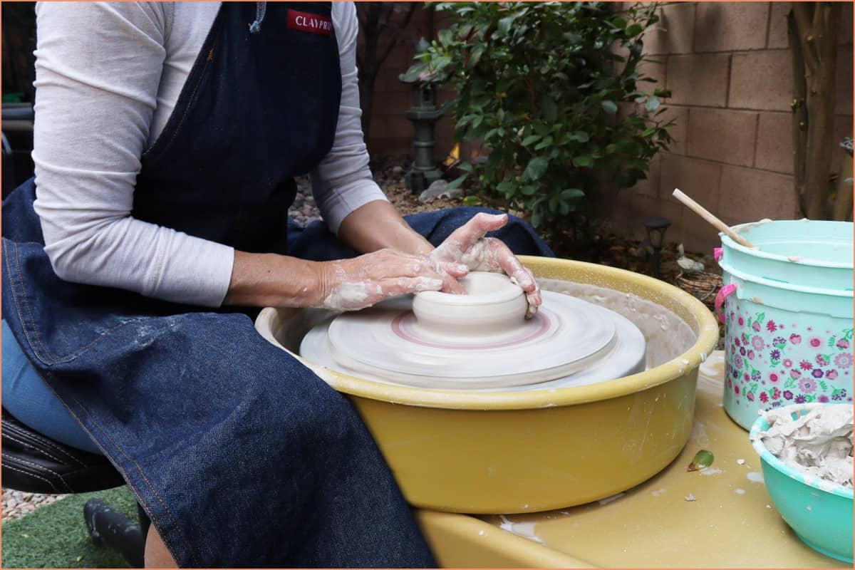 picture if a potter opening the clay