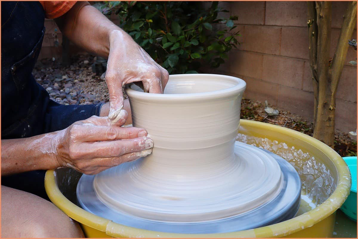 a picture of a potter throwing a large pot 
