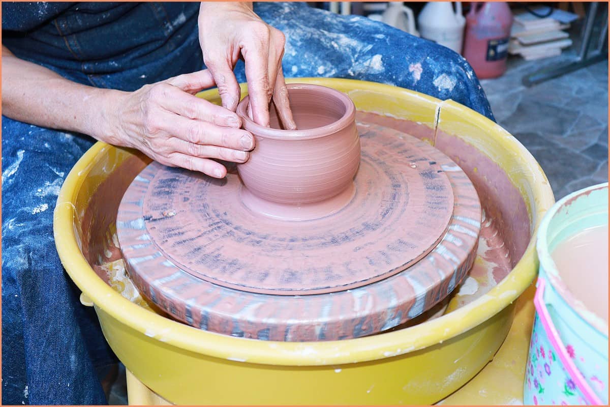 an image of a potter making pottery