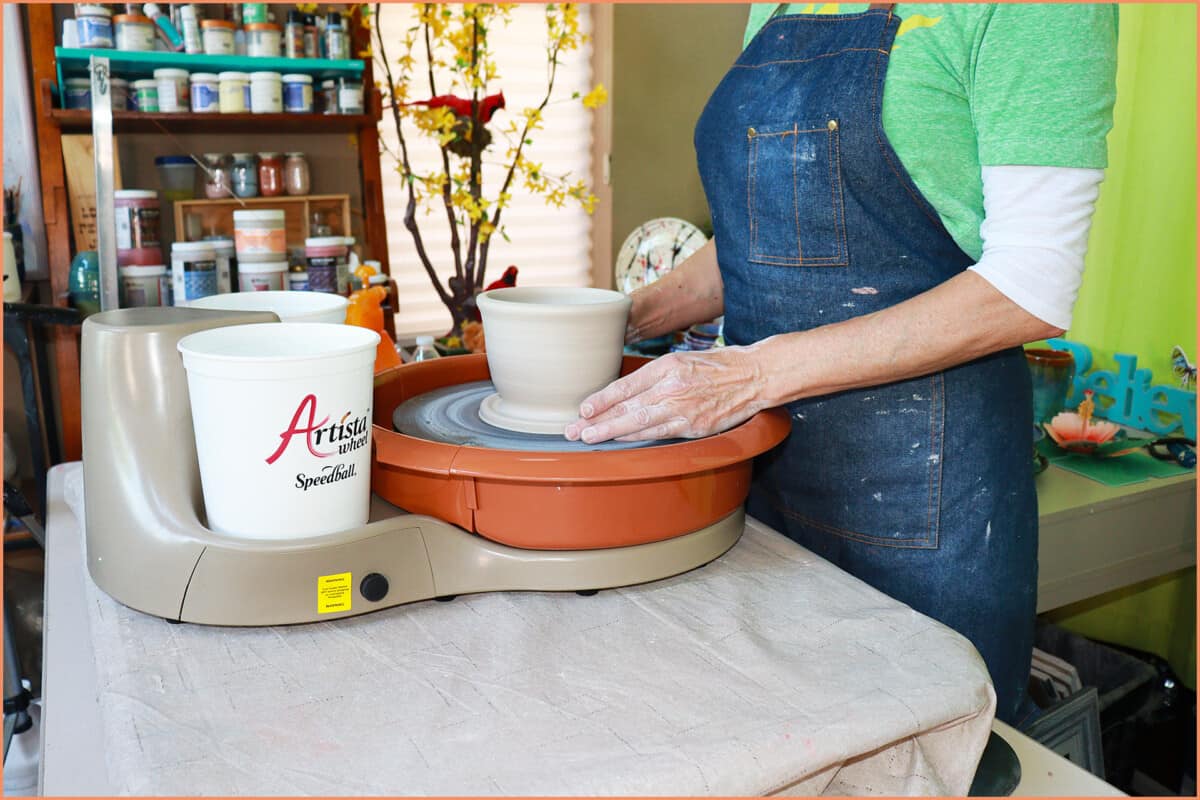 a picture of a potter on the Artista pottery wheel