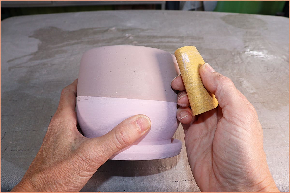 an image of sanding a glaze drip off