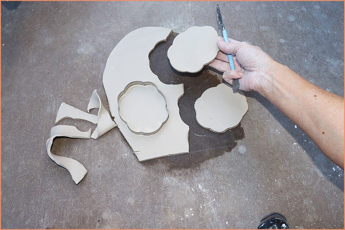 image of a potter Hand Building on concrete