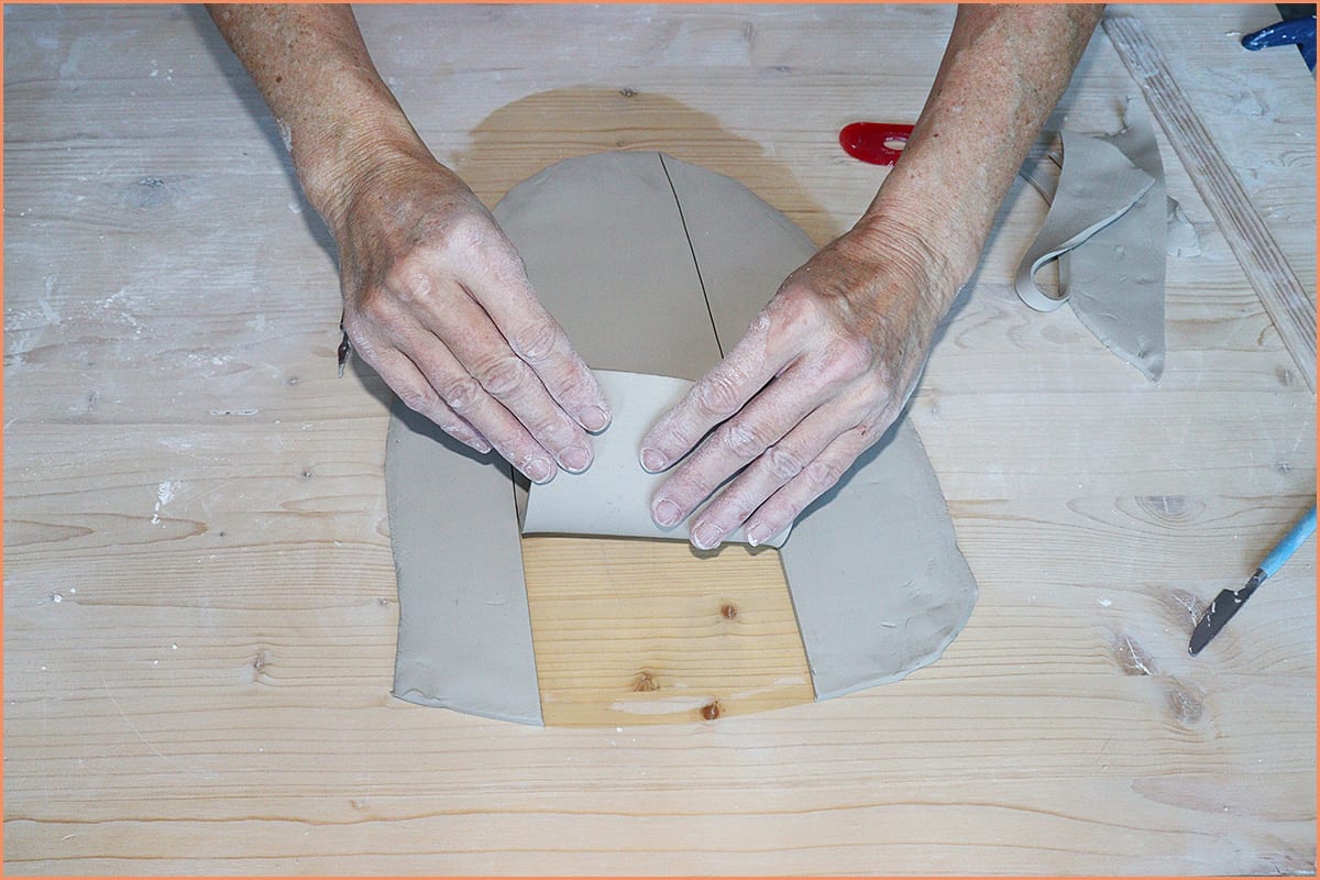 image of a potter Hand building on wood