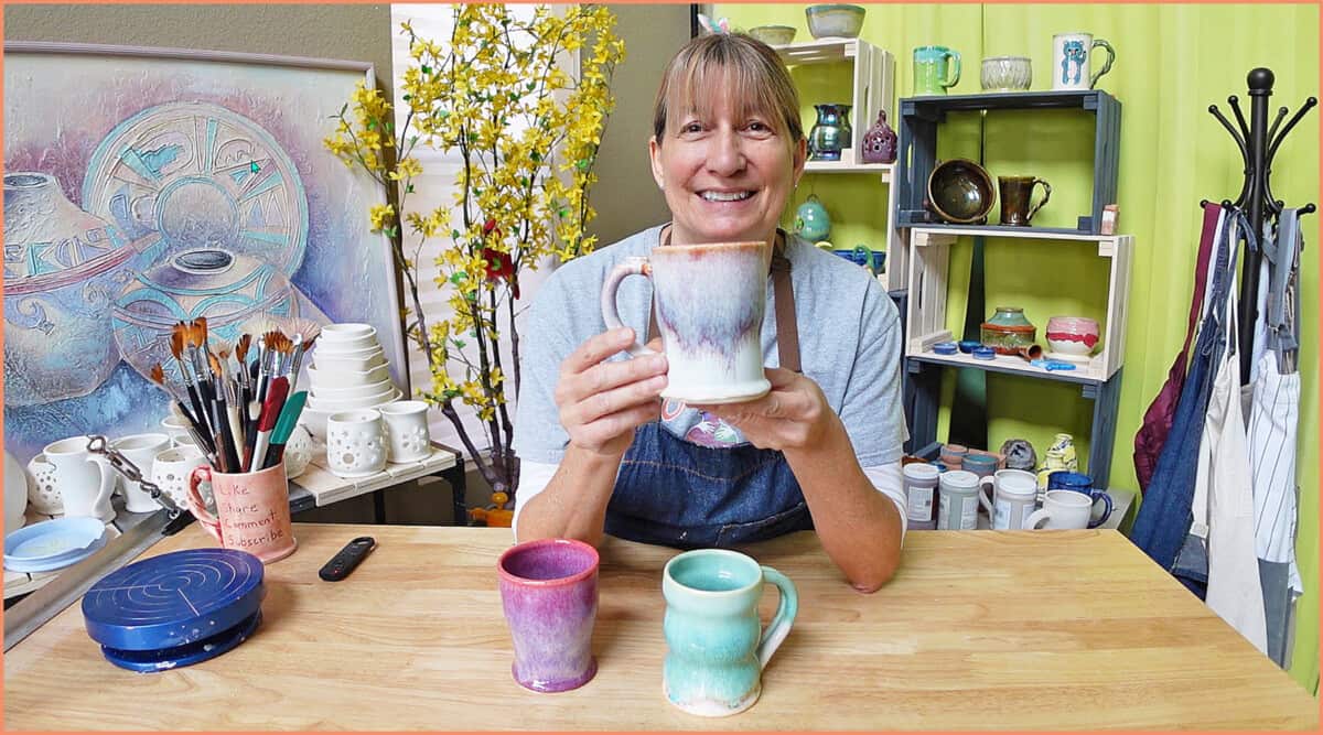 Potter holding up a glazed mug