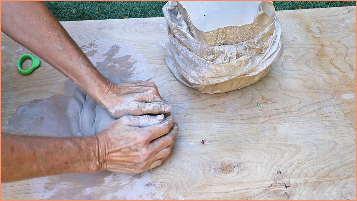 a potter wedging raku clay