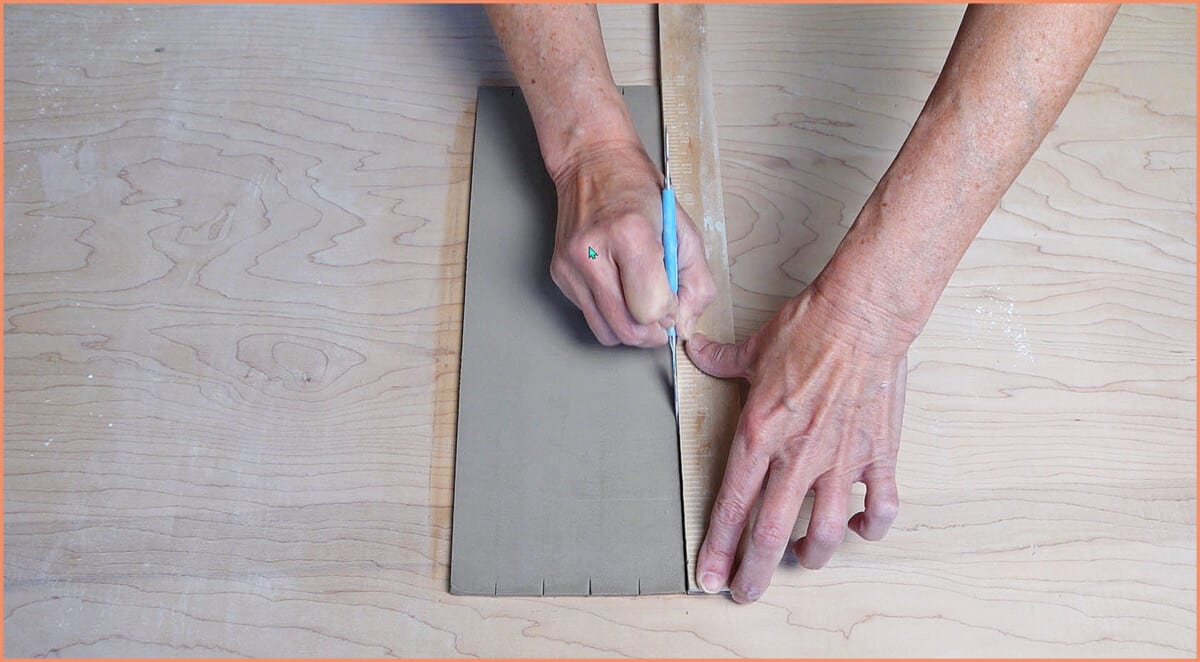 cutting clay with ruler