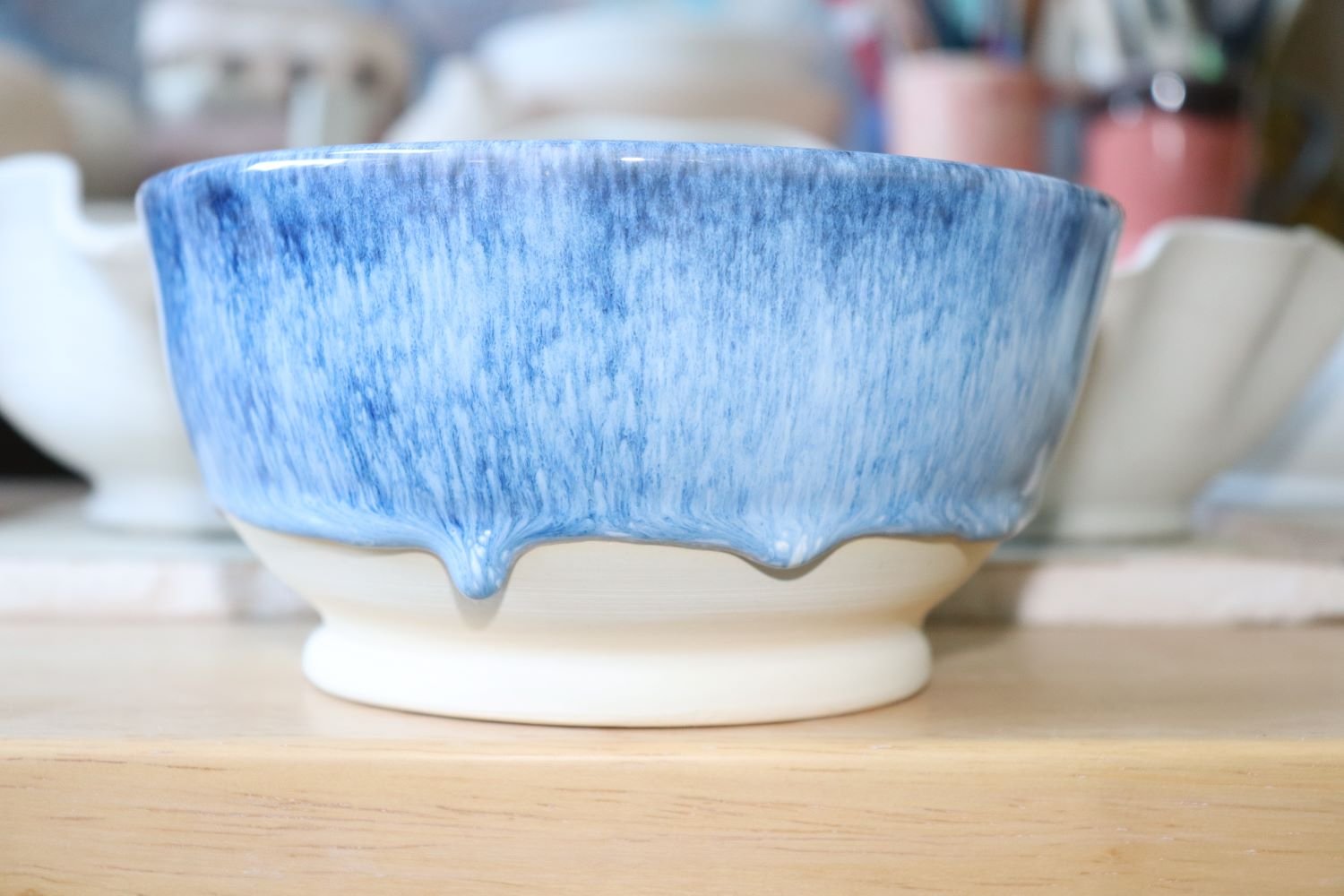 What is The Difference Between Glaze and Underglaze a picture of a bowl glazed with Amaco Sapphire Float over Honey Flux