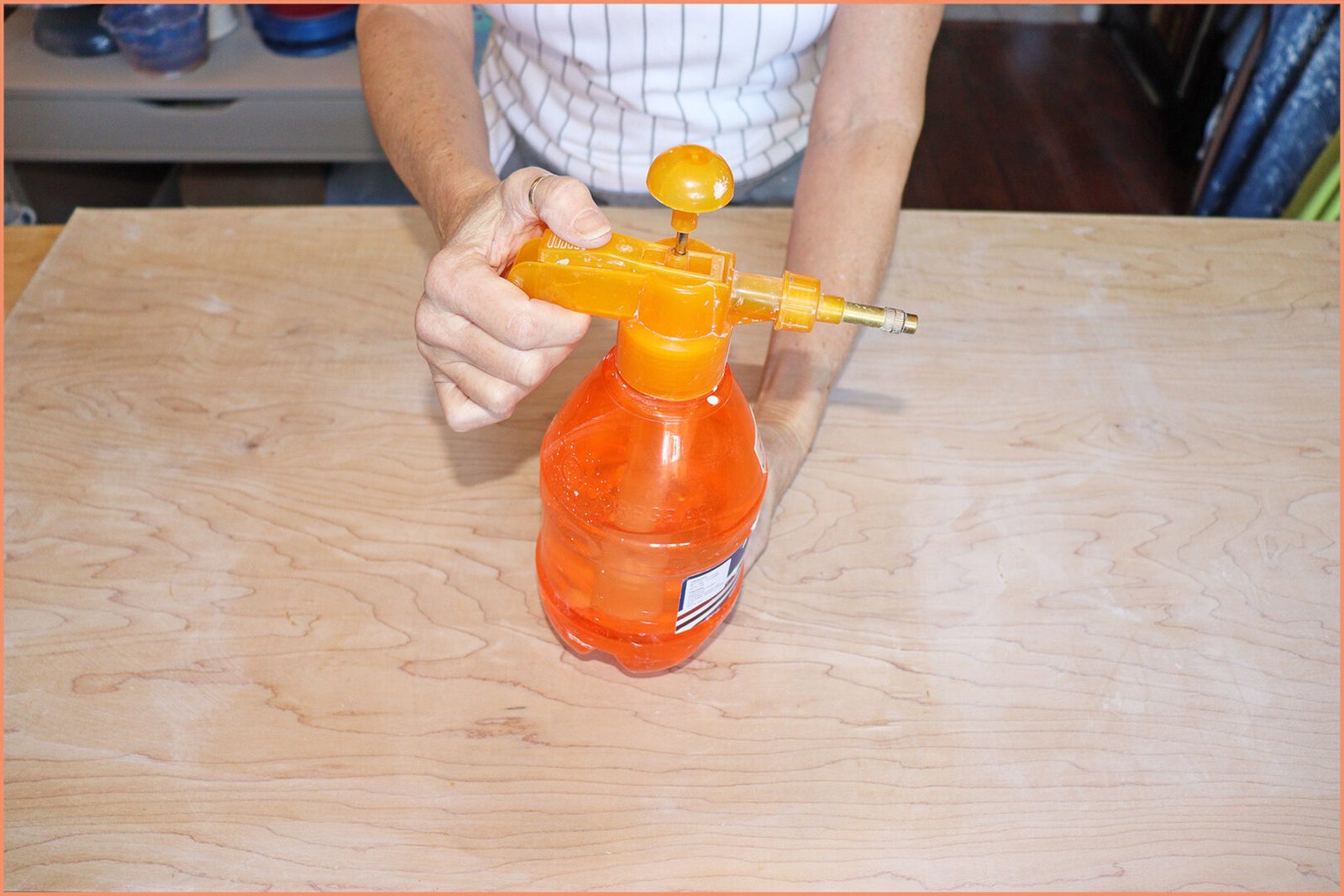 an image of a potter holding a mister spray bottle