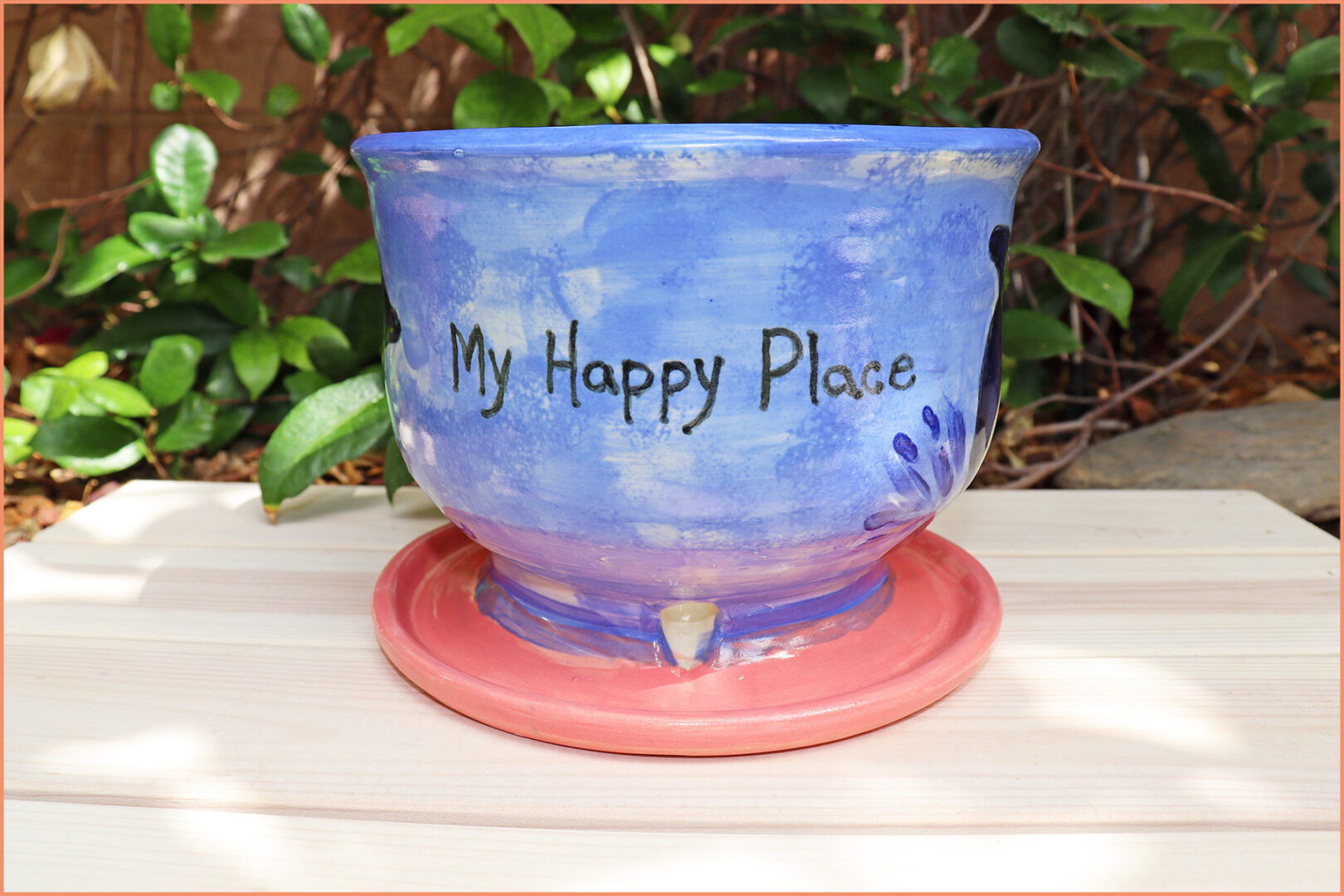 an image of writing on a planter with an underglaze marker 