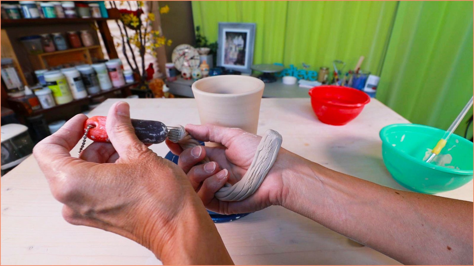 an image of a potter Scoring a handle