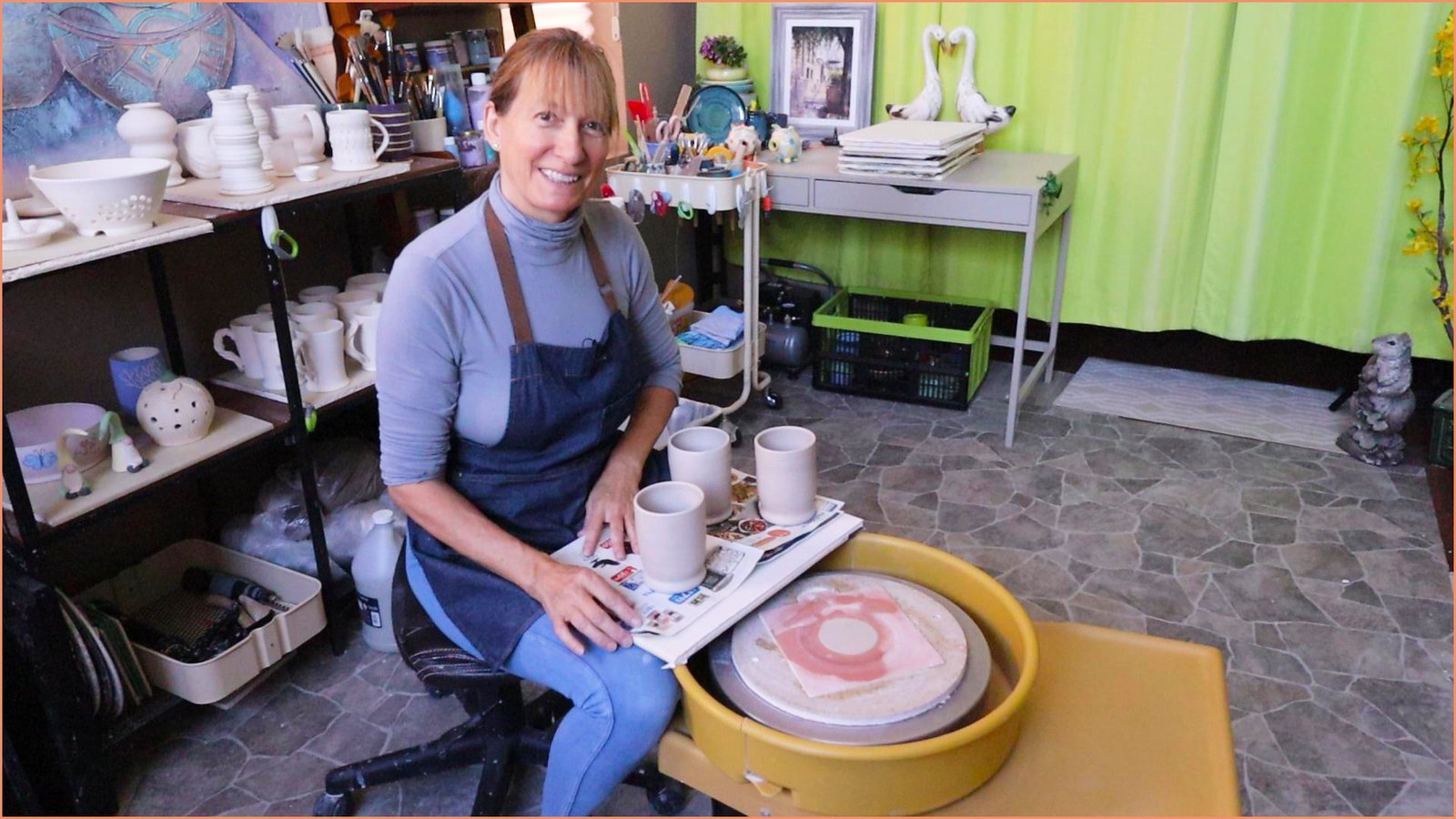 an image of a potter taking a mug off the bat and on a ware board